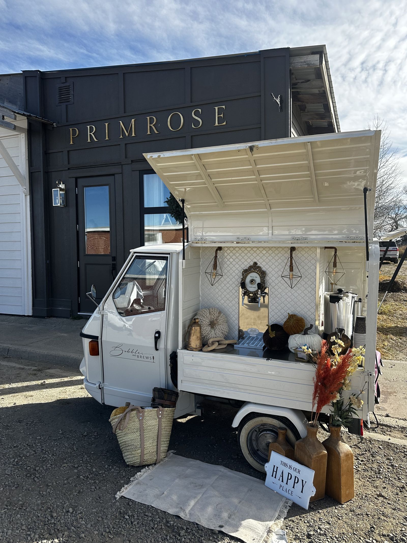 Bubbles and Brews mobile bar activation outside a storefront in autumn, styled with mini pumpkins and pampas grass