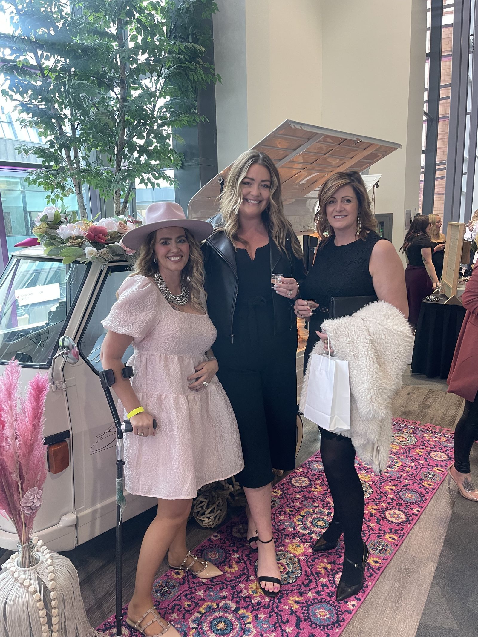 Guests posing together at an indoor Calgary corporate event with the mobile bar
