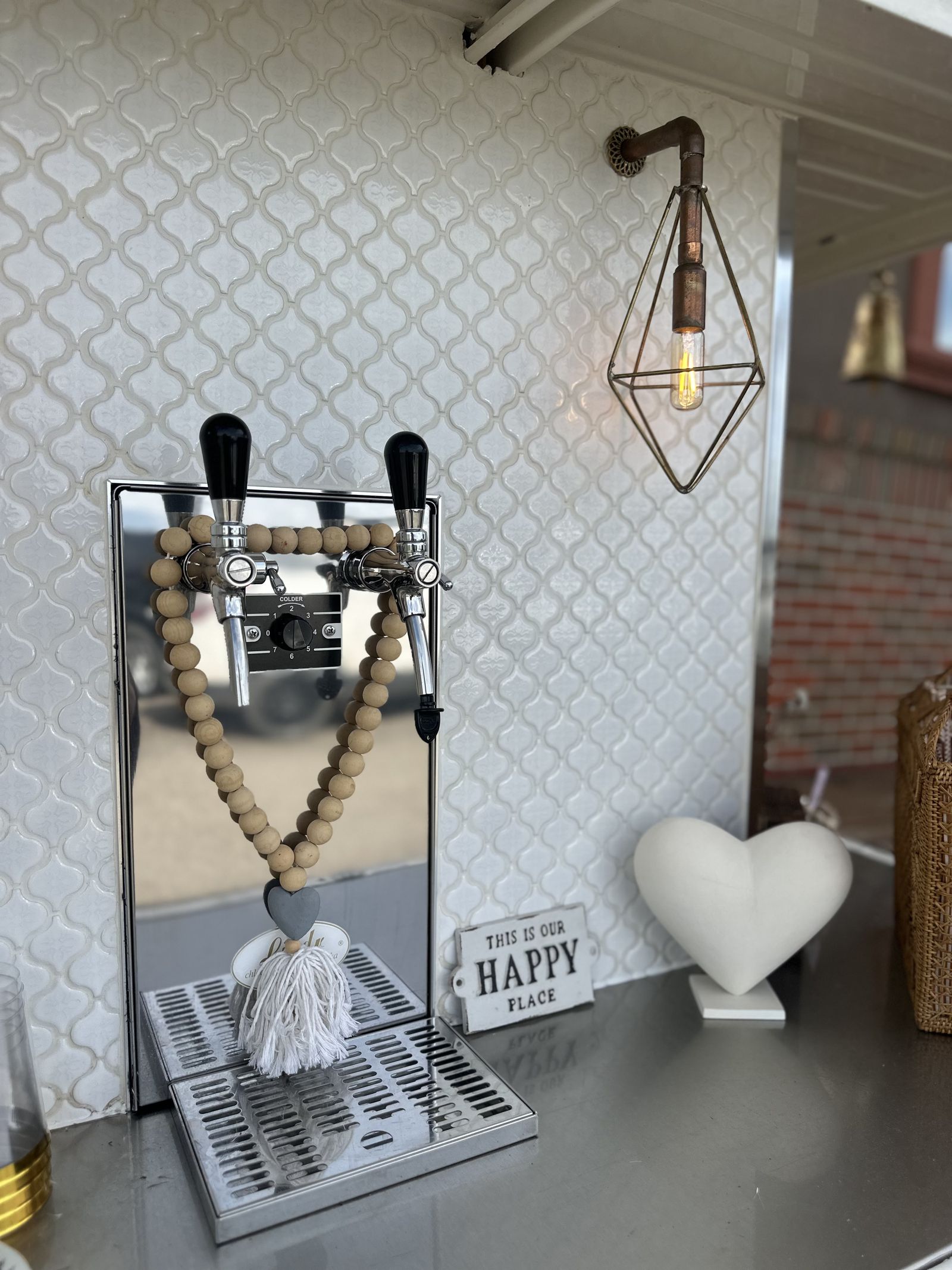 Prosecco truck tap detail styled with dried florals and a 'Happy Place' sign
