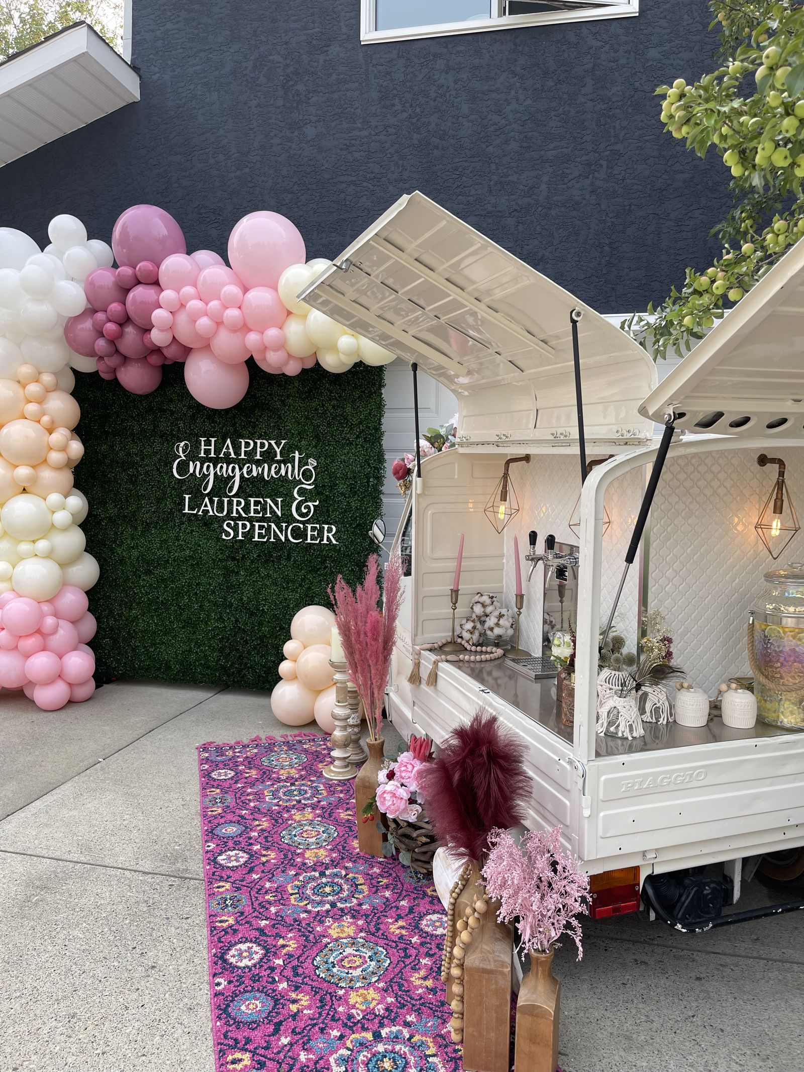 Calgary engagement party with the Bubbles and Brews prosecco bar lit up at dusk under a balloon installation