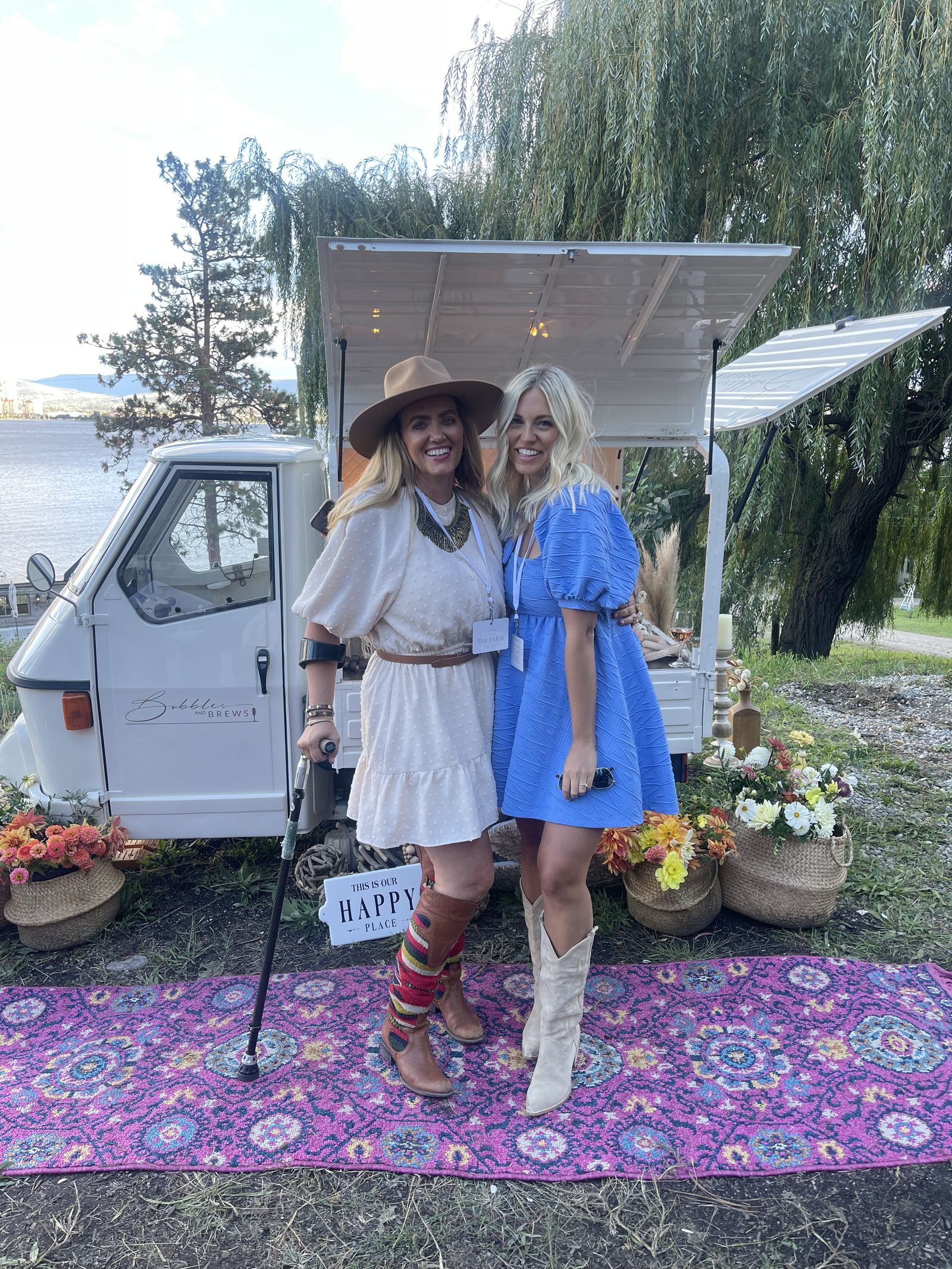 Guests at the Farm Event sharing a toast beside the mobile bar at golden hour, Okanagan Lake in the background