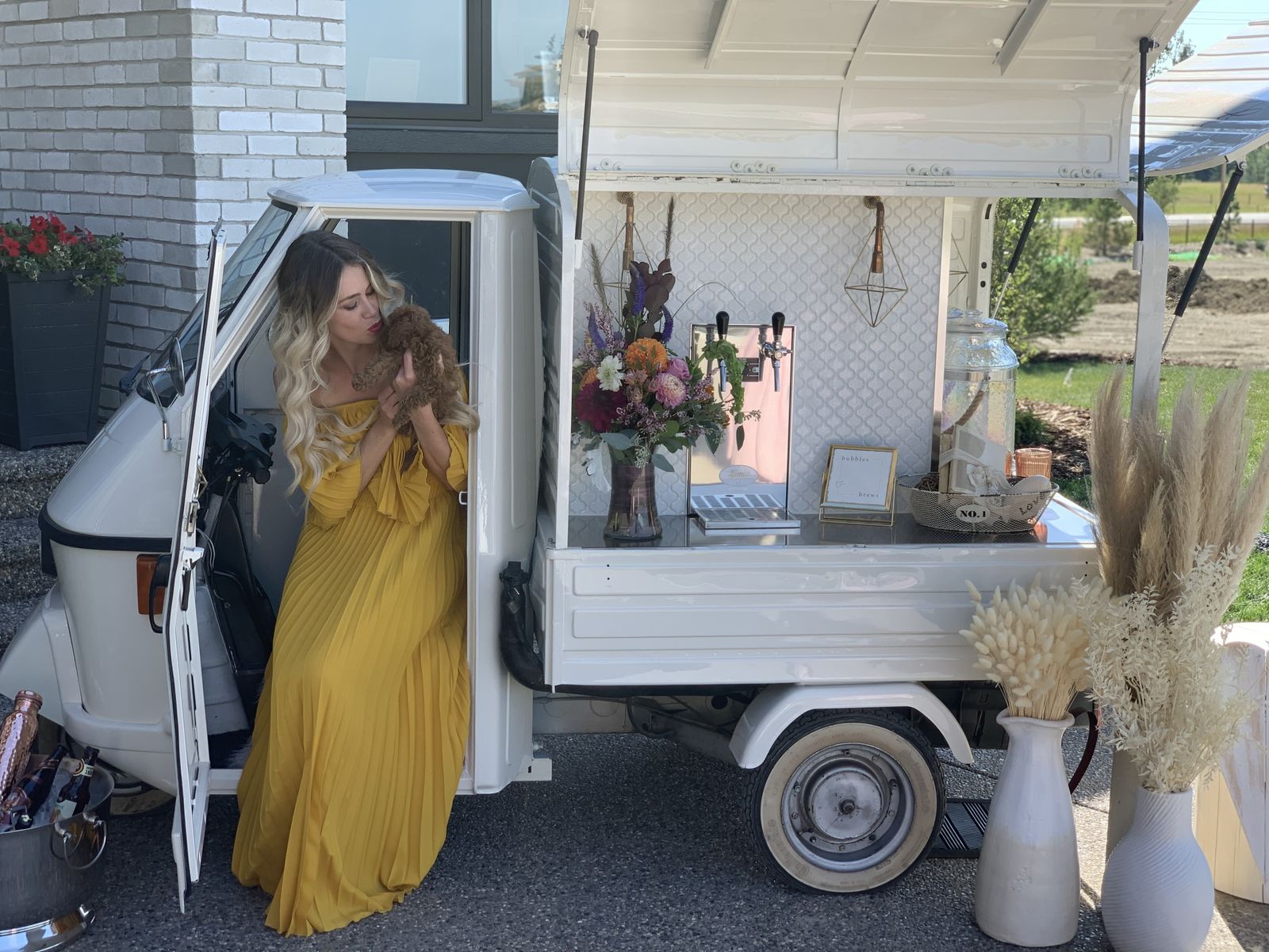 Guest in a yellow dress posed in the open mobile bar cab