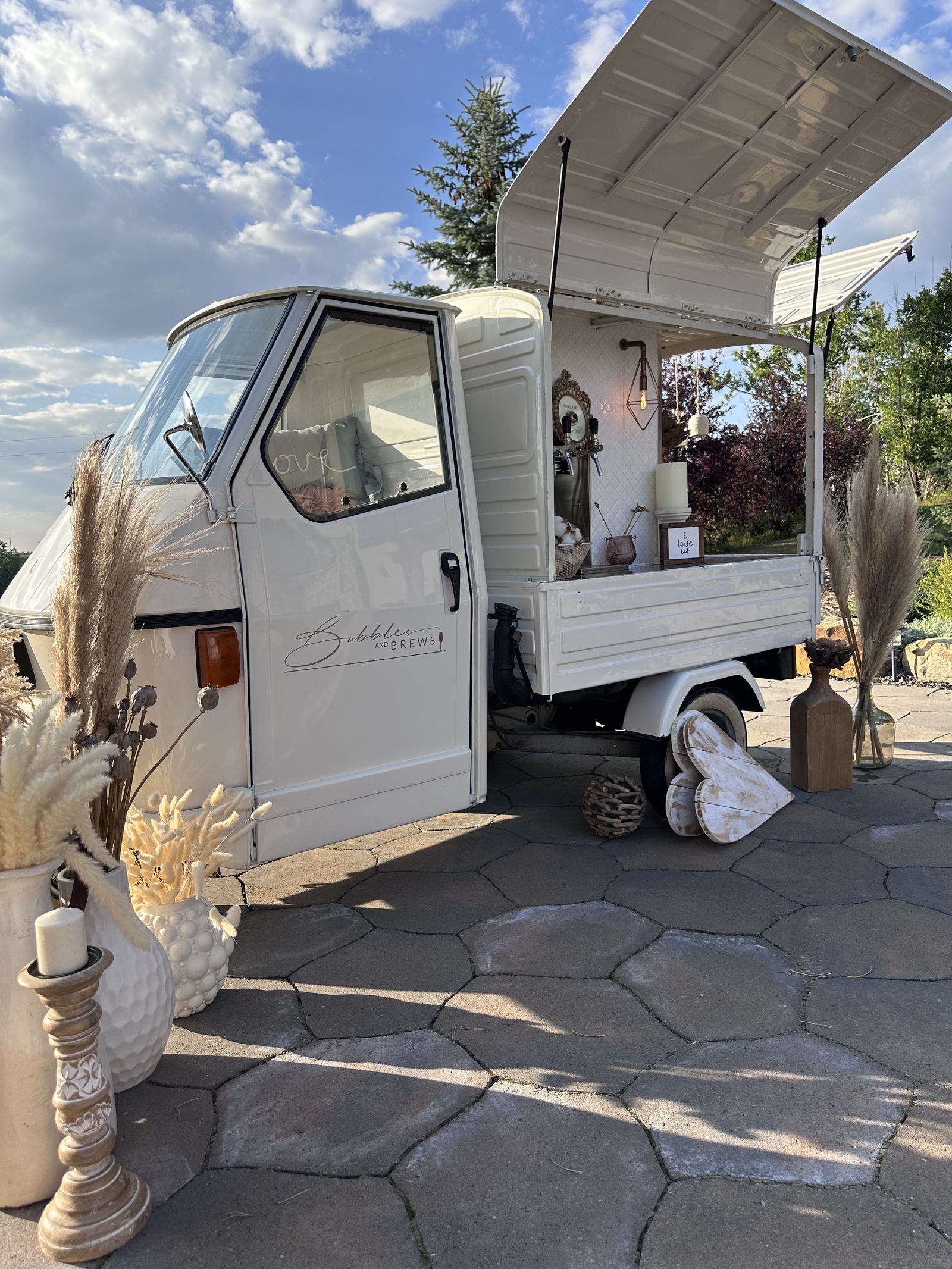 Golden hour view of the mobile bar on a cobblestone patio at a Banff-area mountain resort