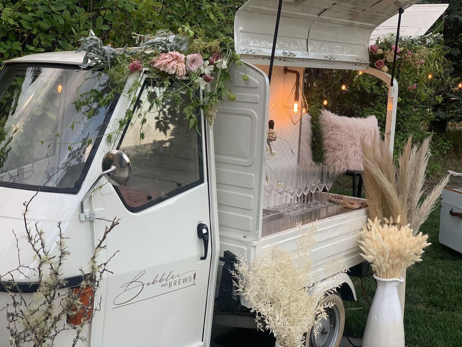 Calgary mobile bar styled with a floral garland on the cab at golden hour
