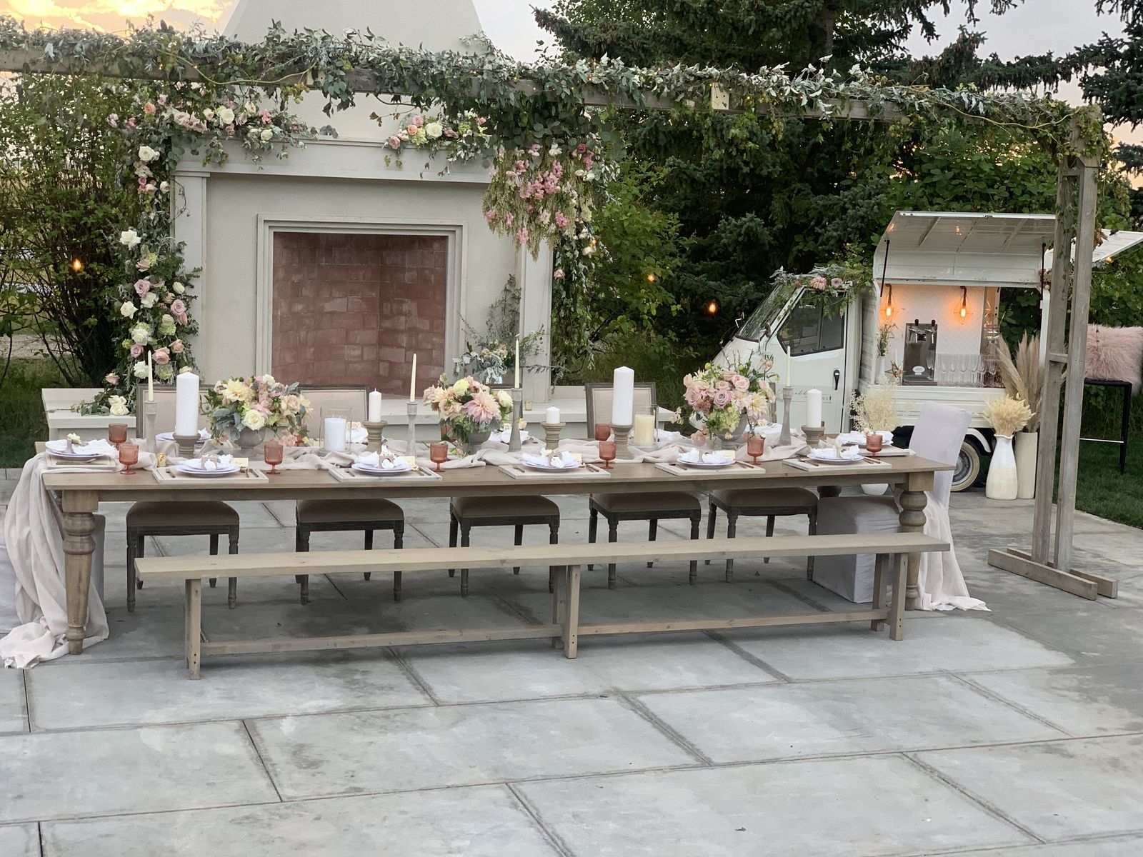 Wide view of a Calgary estate wedding tablescape with the mobile bar and fireplace backdrop