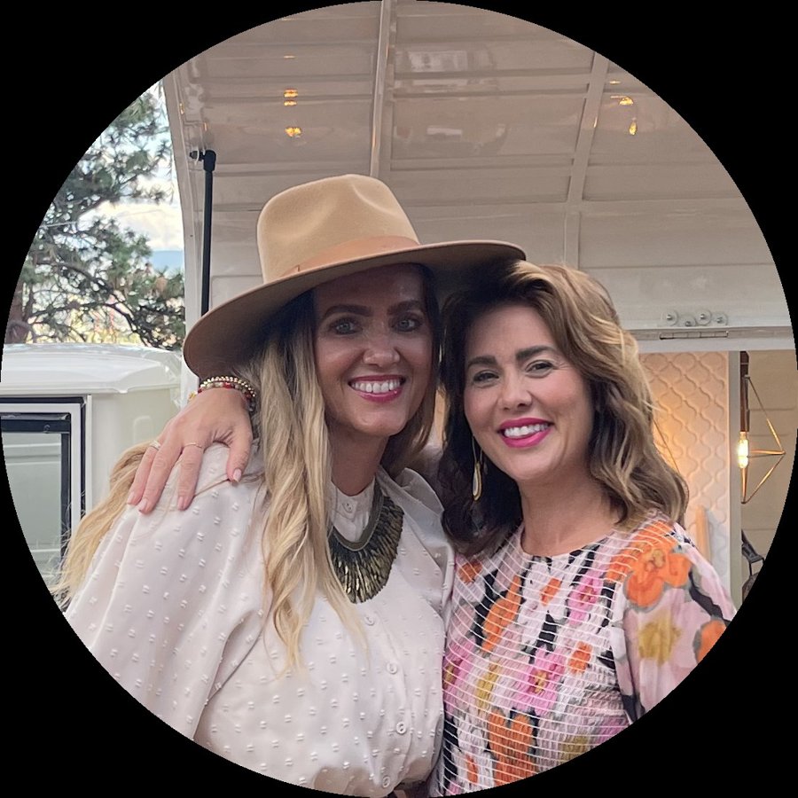 Two friends laughing together at a Bubbles and Brews prosecco bar event, in front of the vintage Piaggio Ape mobile bar