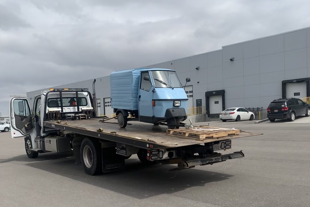 The Bubbles and Brews vintage Piaggio Ape arriving by flatbed tow truck before restoration began, 2020