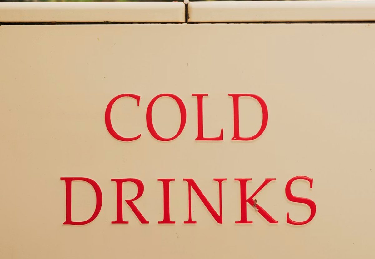 Vintage red 'Cold Drinks' lettering on the side of the Bubbles and Brews bar, illustrating the drink calculator tool