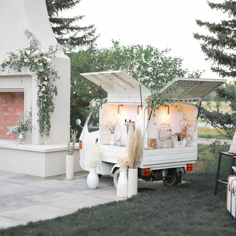 Bubbles and Brews Canada vintage Piaggio Ape mobile bar parked at an outdoor event